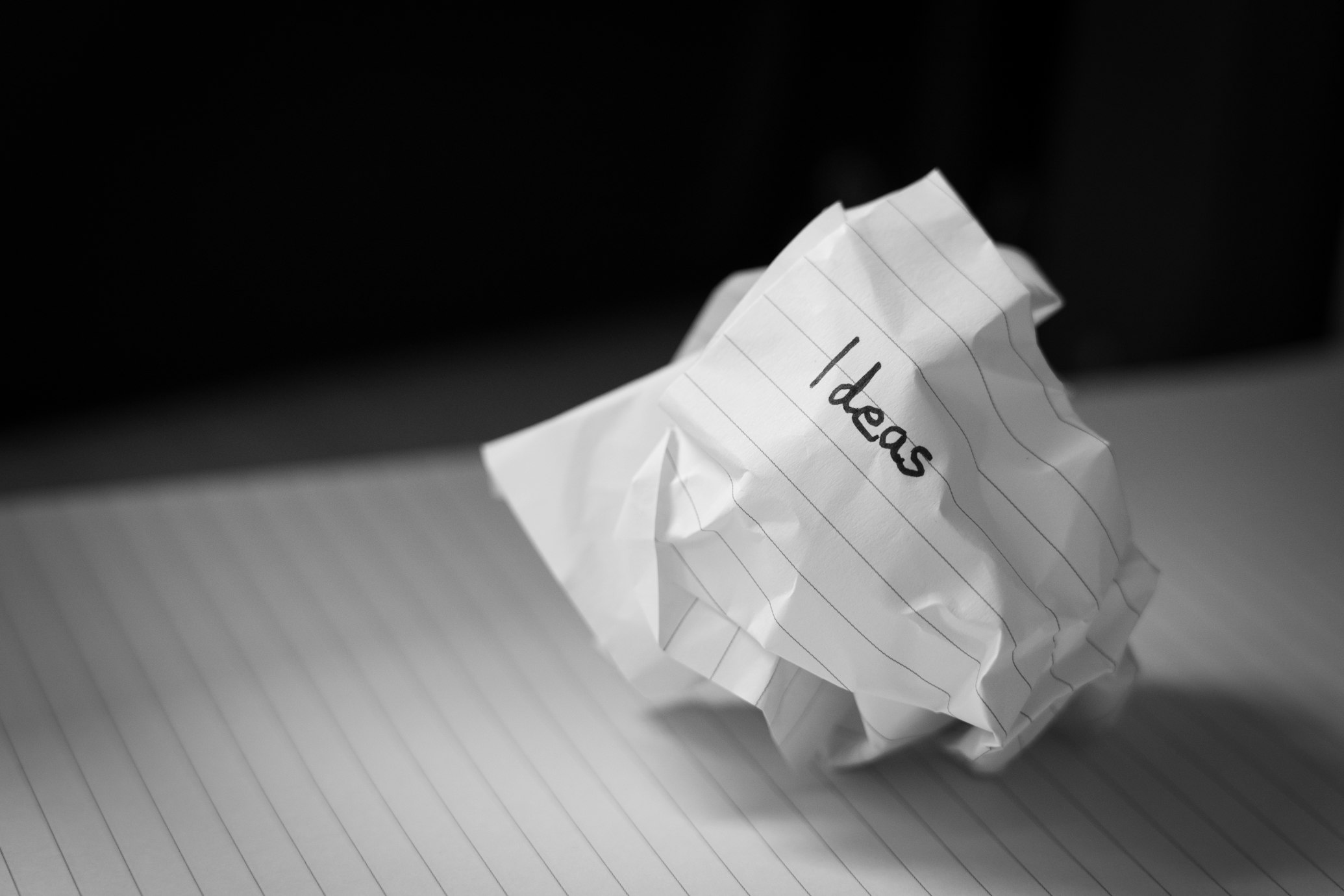 A person writing ideas on sticky notes